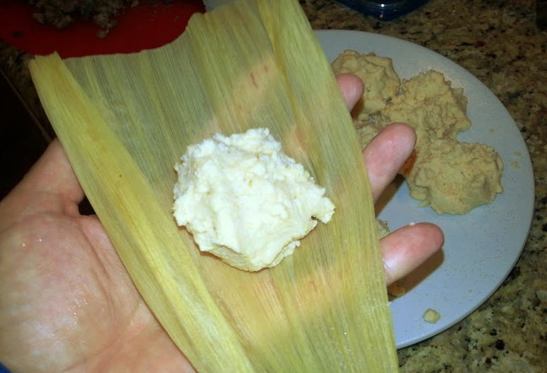 Lamb Tamale put masa on husk